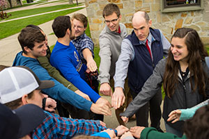 Students with hands all in