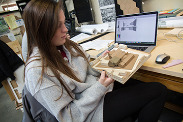 Architecture student working on her model