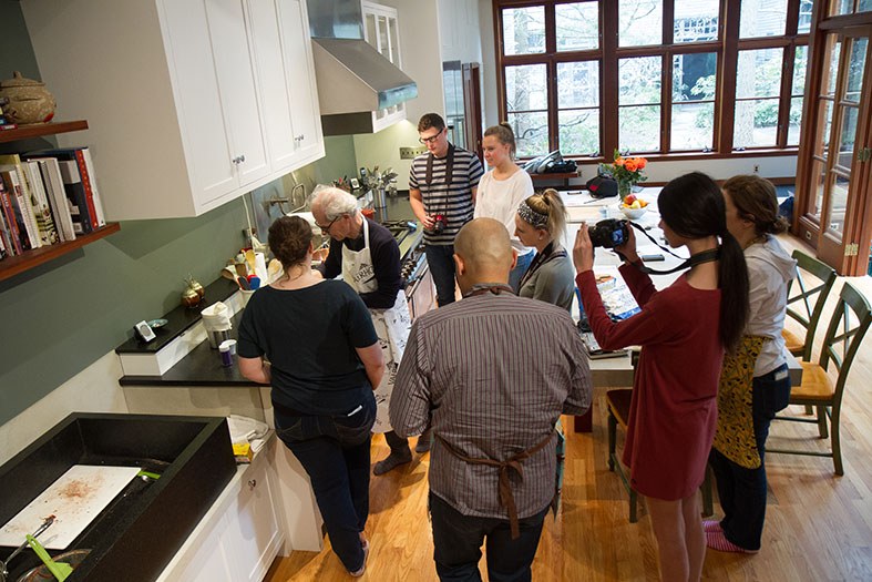 Students watch as Schuhmacher makes the macaron cookie mix.