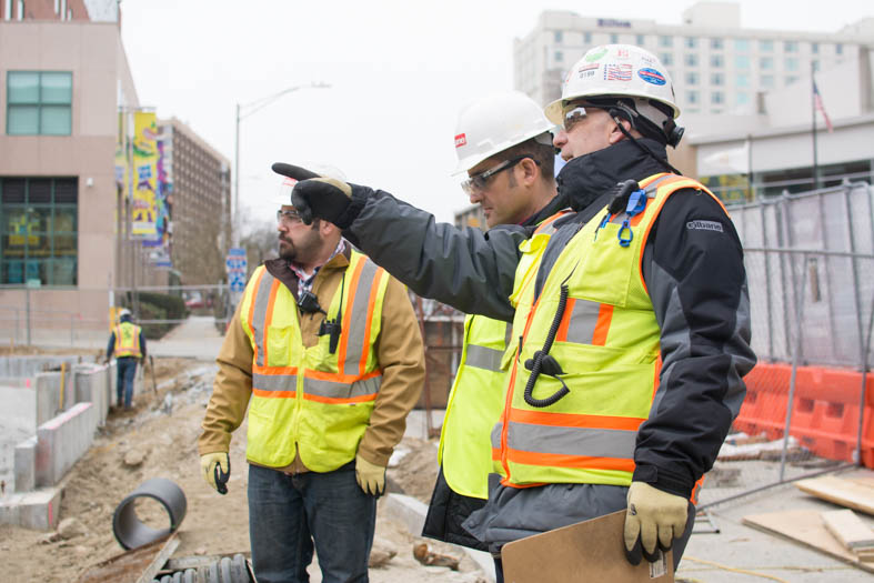 Dave Cameron points across the construction site to another piece of exposed foundation wall. 