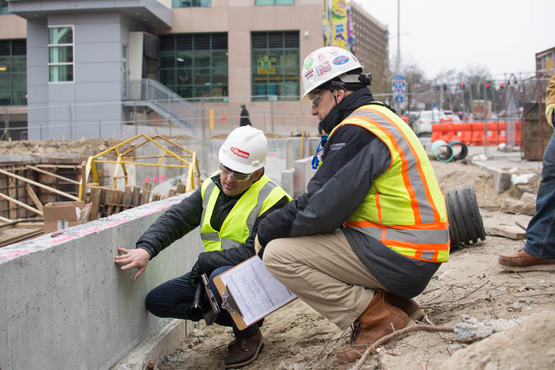 Dave Cameron shows the architect of the 176-room Residence Inn in Providence a portion of the foundation wall that will be exposed to public view.