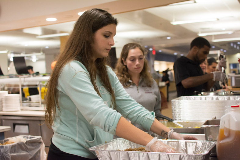 Emma S. placing food on tray