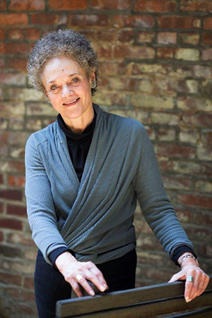 Kathleen Cleaver in front of a brick wall