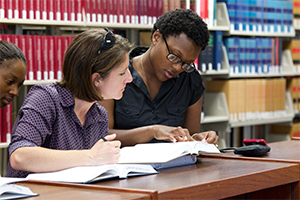 Students looking at a book.