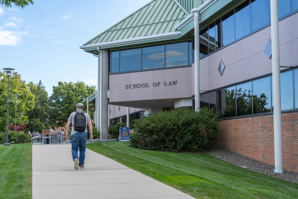 A student walking by the Law School building