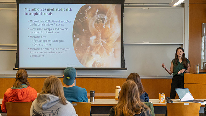 Meriel McGovern presenting her Honors Capstone project to a group of people.