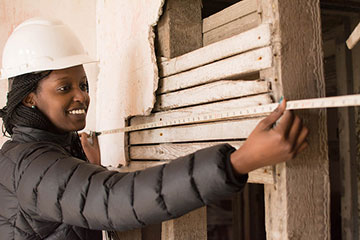 Engineering student examines a structure.