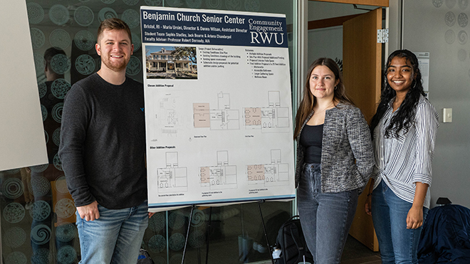 Three students pose with their SASH poster 