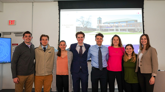 A group of students standing in a row inside the library 