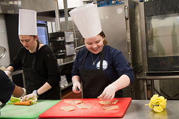 Students cooking in the Iron Chef meal-budget challenge.