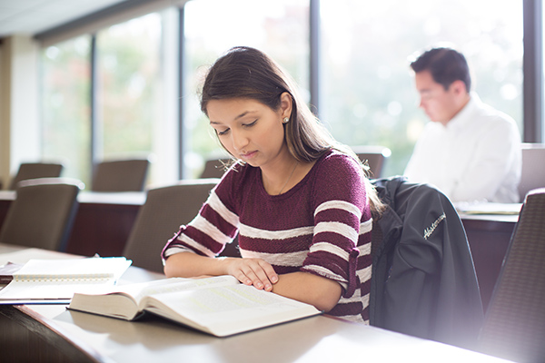 A student reading a book in a classroom 