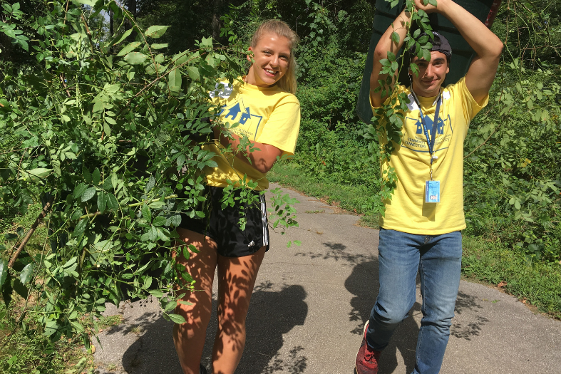 Students clearing out brush. 