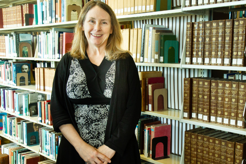 Headshot of professor in library. 