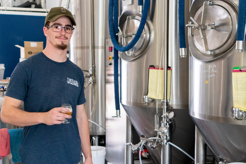 MacConnell holding brewed beer.