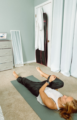 Person doing a yoga stretch on the floor. 