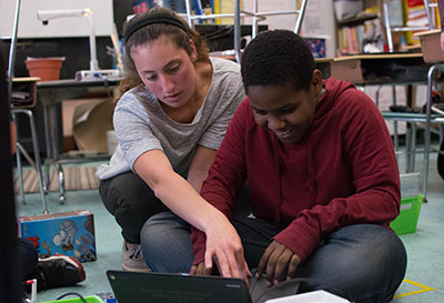 A student teacher works with a student