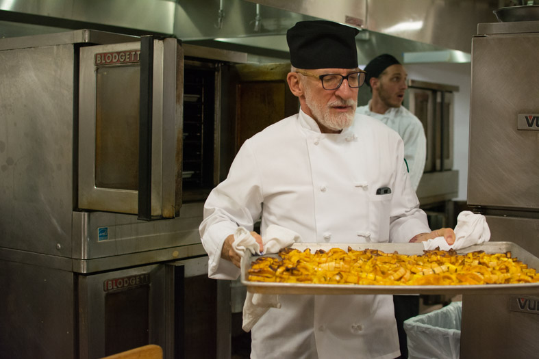 Chef taking squash out oven