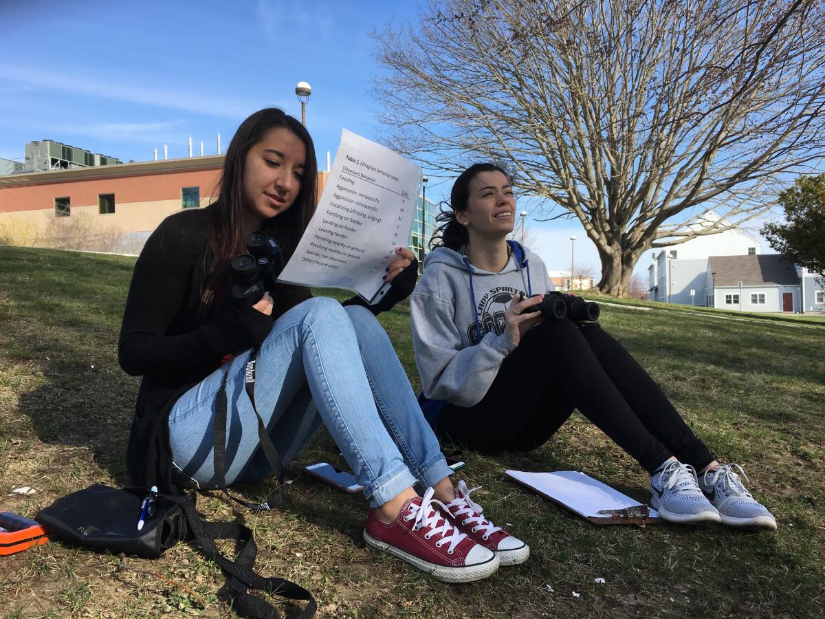 Students write in a notebook.