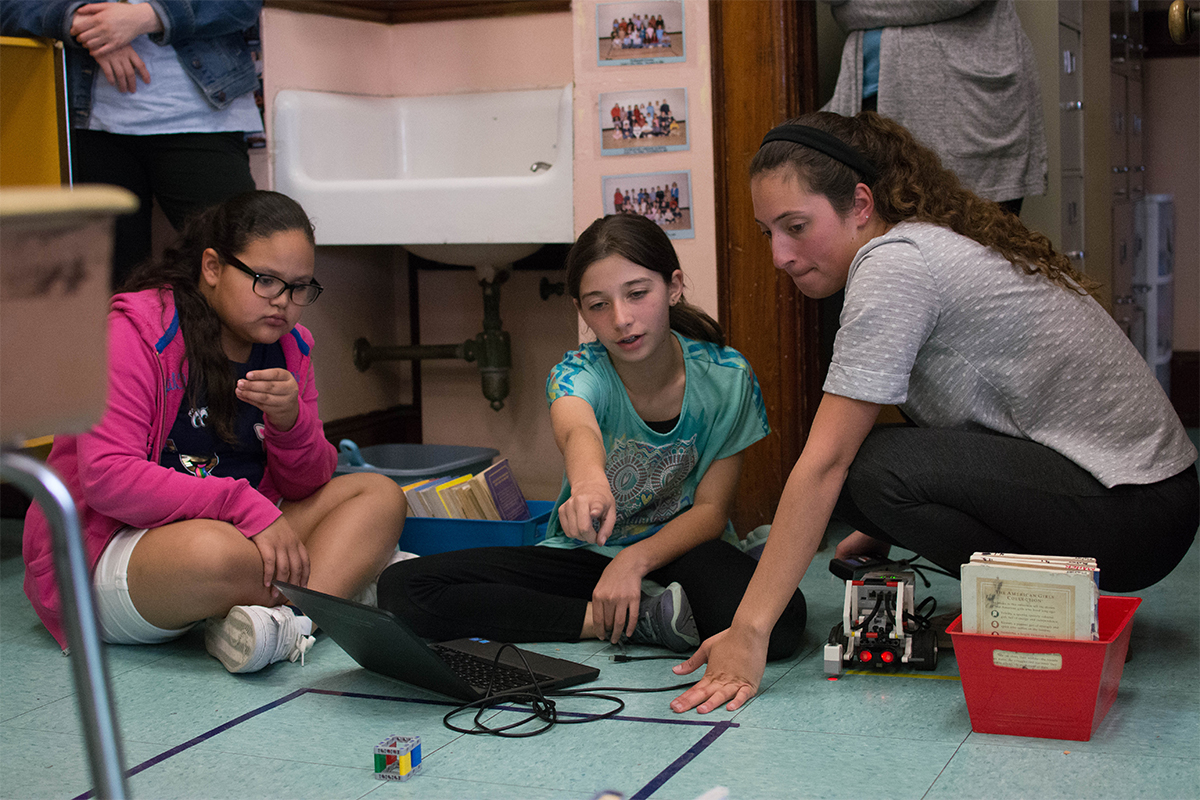 RWU student works with two female students