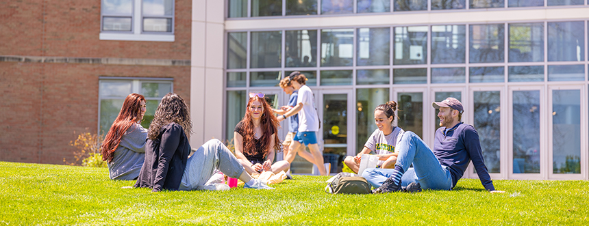 Students sit together outdoors