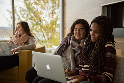 image of RWU students collaborating on a laptop