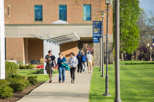 Students walking on campus on a sunny day