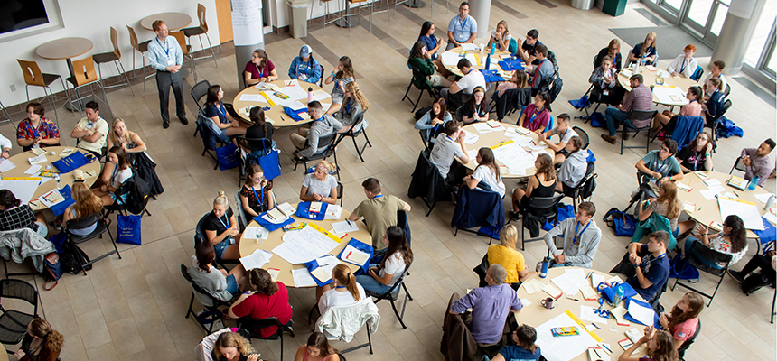 image of tables full of collaboration at Honors retreat