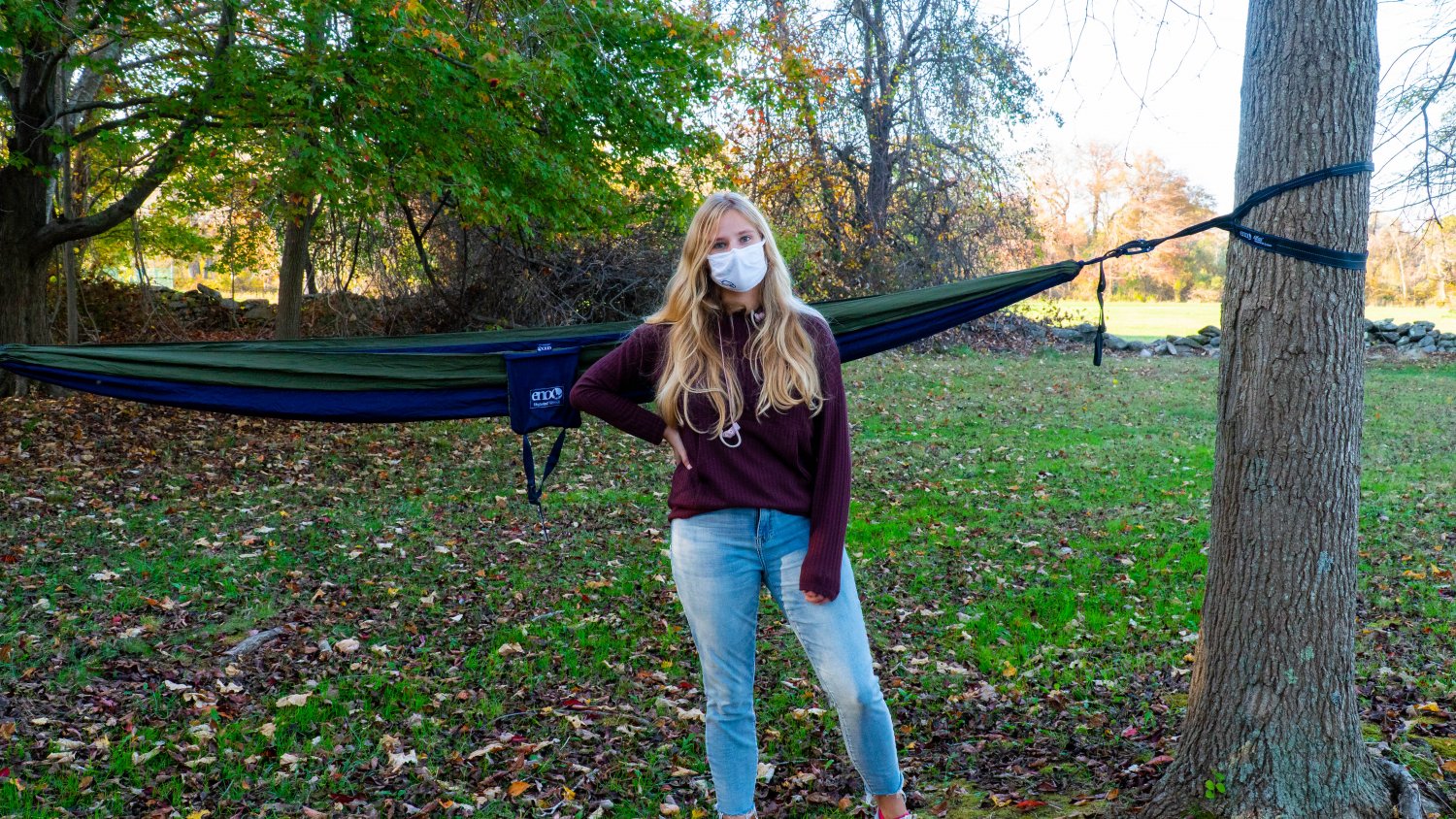 Senior stands in front of hammock ready to study