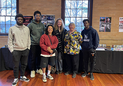 Students and Professor stand together at event