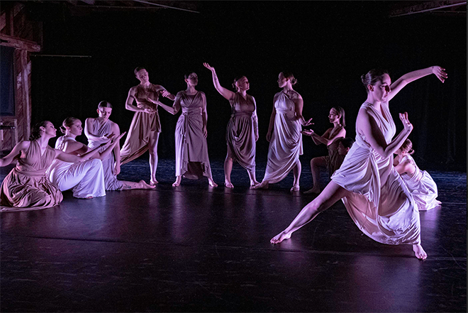 A group of dancers perform on stage