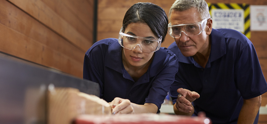 image of instructor and student wearing safety glasses working in carpentry class