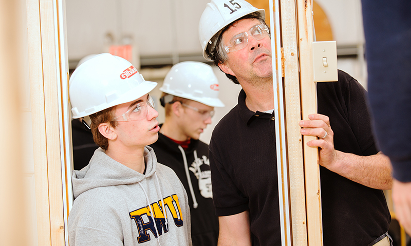 Instructor assisting a student on a project.