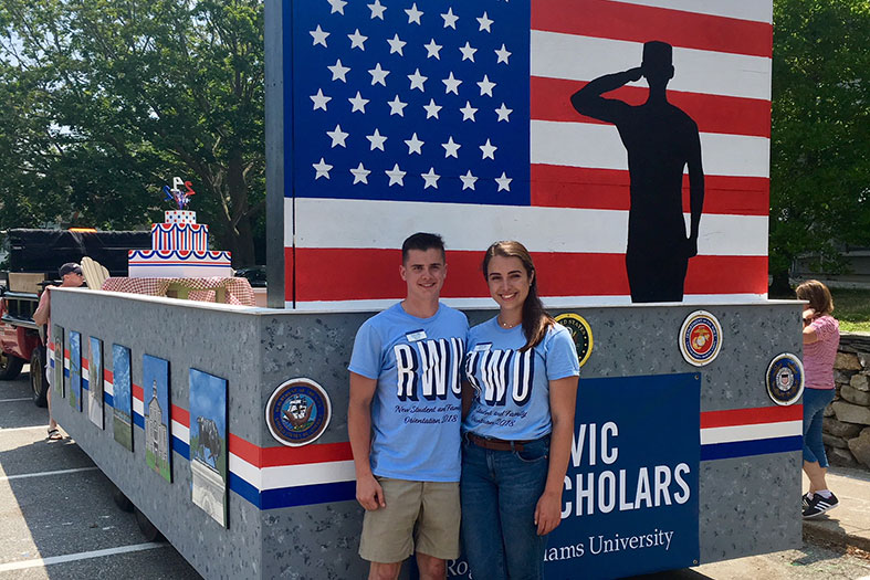 Student team leaders pose in front of float