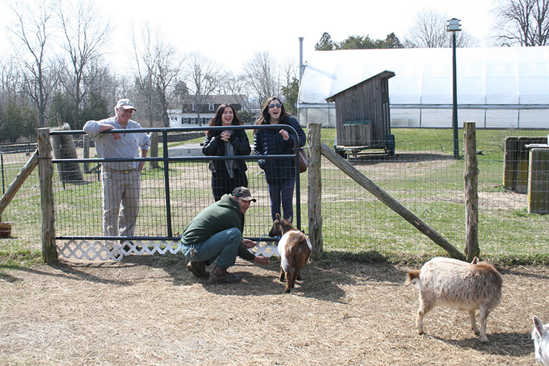 Journalism students observe news segment on goats.