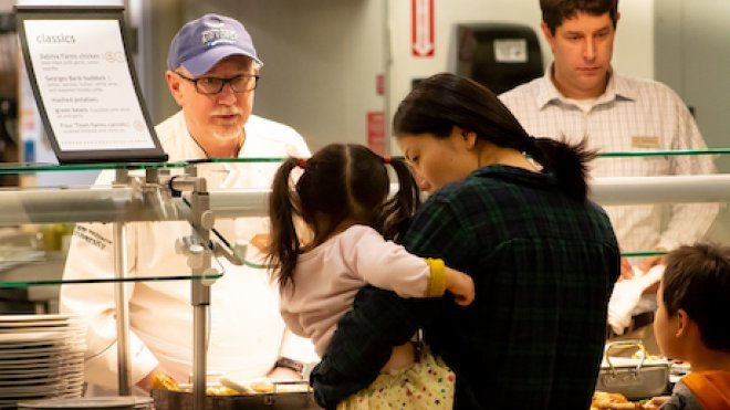 RWU member serving food to coast guard family