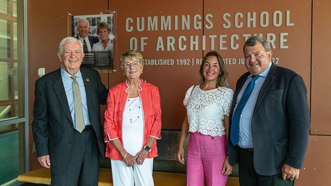 Bill and Joyce Cummings, Heidi Maes and President Miaoulis pose in front of school sign.