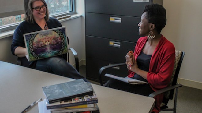 Two faculty members have a discussion. 