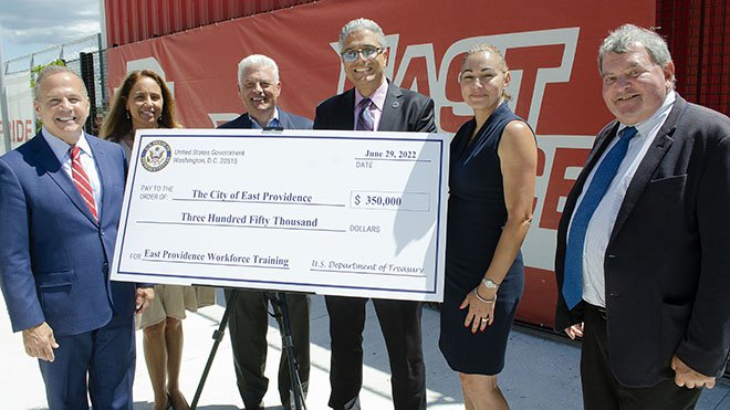 RWU, federal and local leaders hold a check for $350K