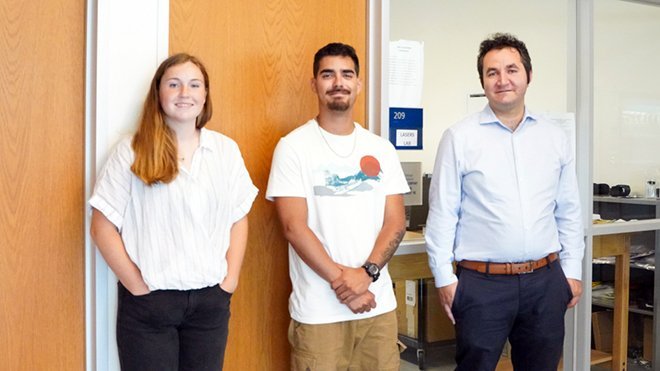 Engineering majors, junior Hunter Phillips and senior Santiago Armas, with Assistant Professor of Engineering Ahmet Akosman outside the Lasers Lab. 