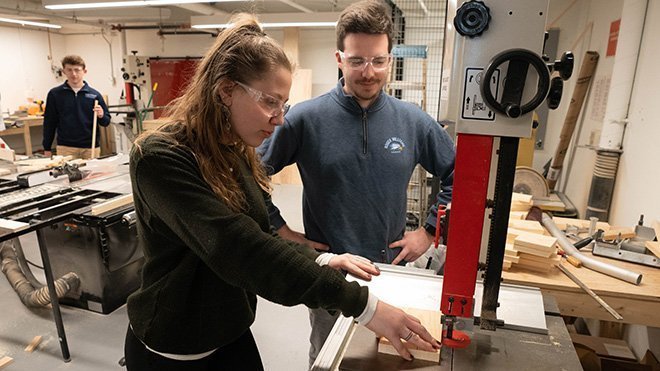 Two students working in the woodshop in the Cummings School of Architecture building