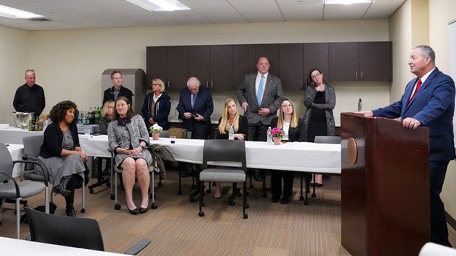 Michael Forte, chief judge of R.I. Family Court, stands at a podium to address a room full of people.