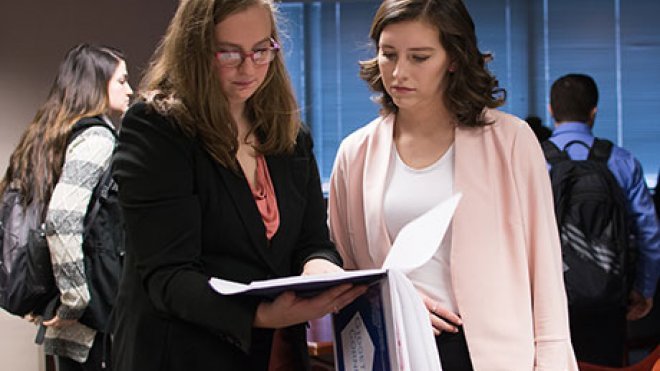 Two students looking over a document.