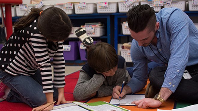 RWU student working with two students