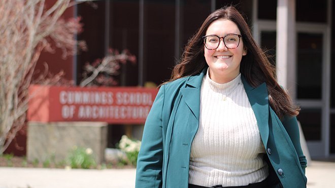 A photo of Renee Parry in front of the Cummings School main entrance 