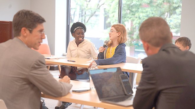 Justice Camp attendees engage in a debate with investigative journalist Tim White and Providence Mayor Brett Smiley.