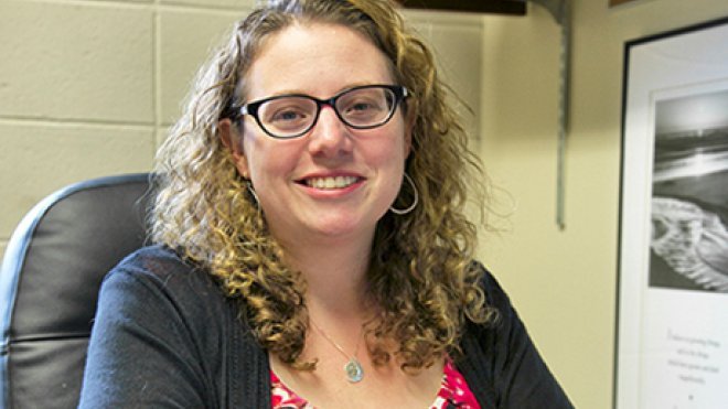 A photo of Professor Russano at her desk.