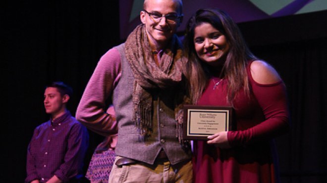 Student and staff member pose with award.
