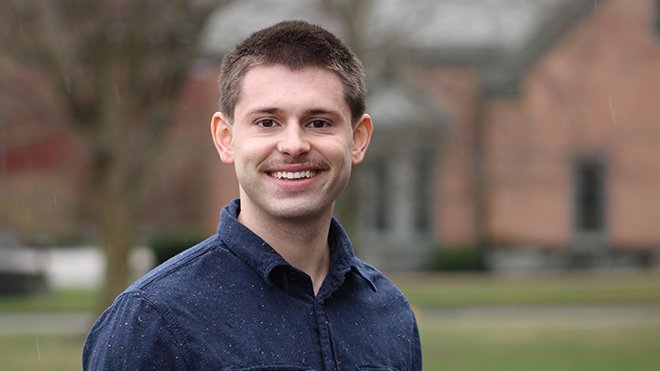 Senior Will Nichols poses for a photo outside the School of Law.