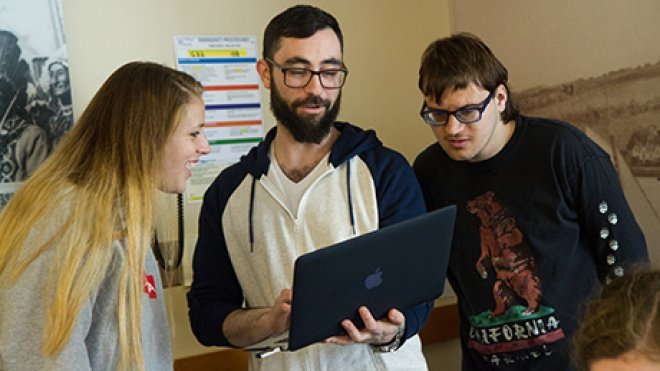 Students looking at a laptop