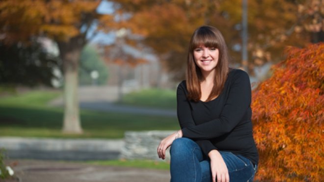 Student sits in the university quad.